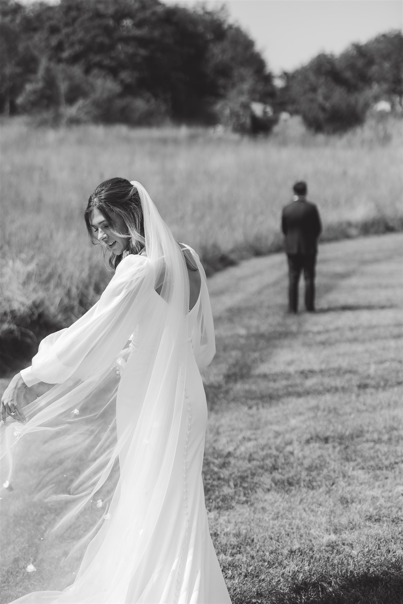 Bride with veil walking to their first look.